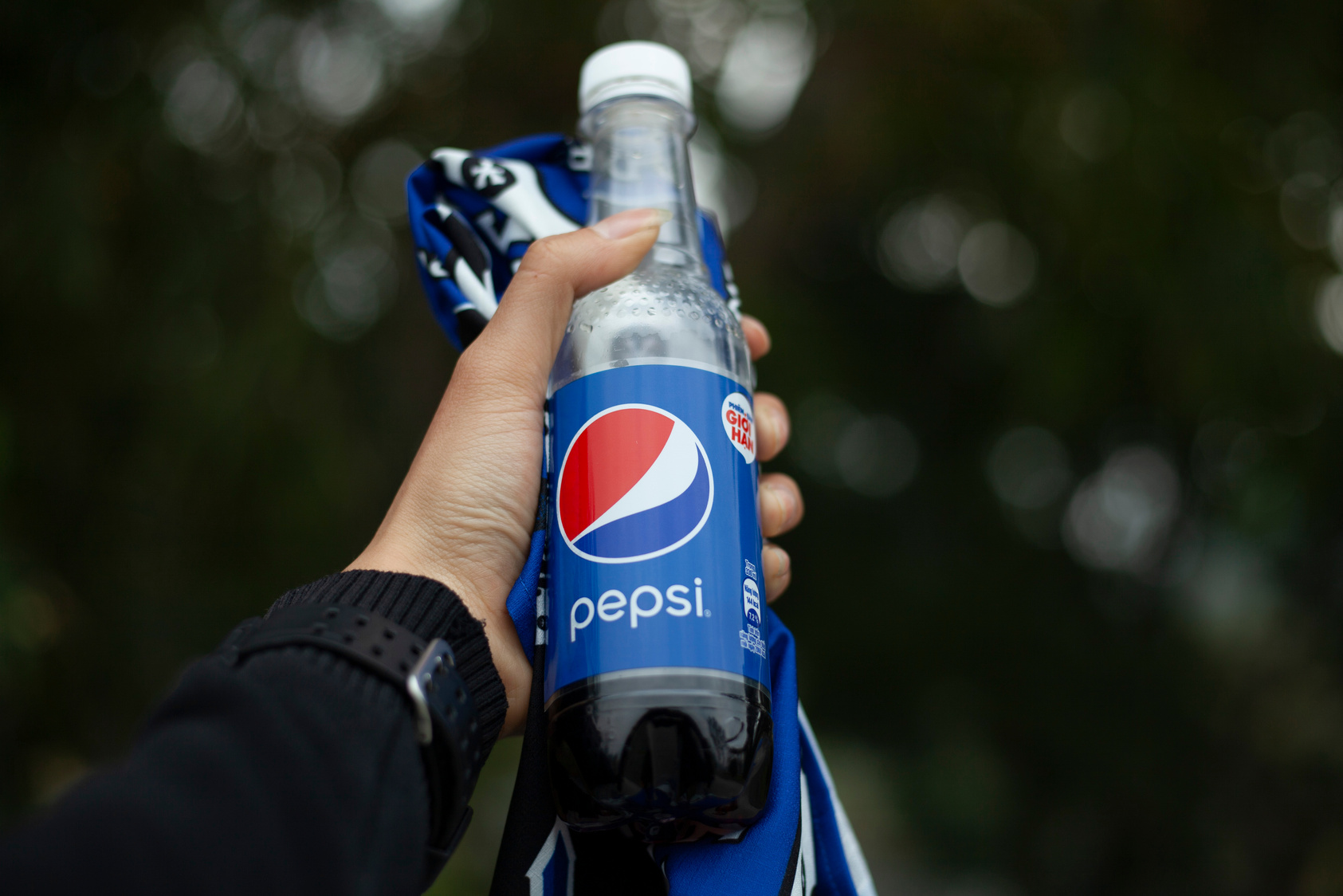 A Person Holding a Bottled Drink